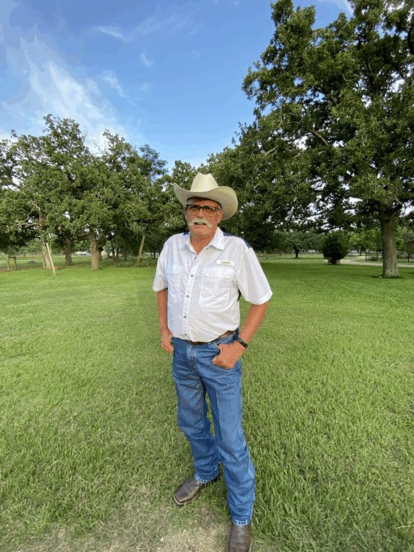Man in cowboy hat on grassy field